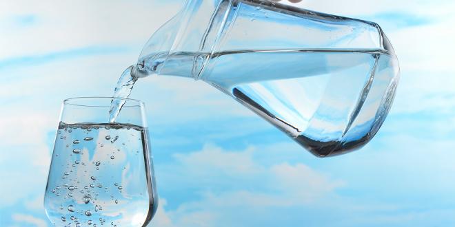 A pitcher of water pouring out into a glass.