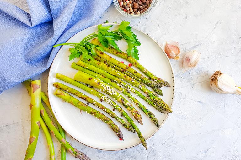 a plate of asparagus with garlic